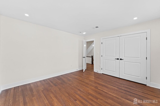 unfurnished bedroom with recessed lighting, visible vents, baseboards, and dark wood finished floors