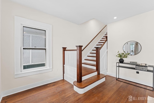 stairway featuring recessed lighting, baseboards, and hardwood / wood-style floors