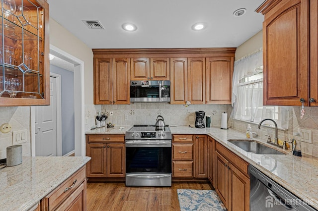 309 Sharon Way Unit A, Monroe, NJ 08831 - kitchen with light stone counters, visible vents, stainless steel appliances, and a sink