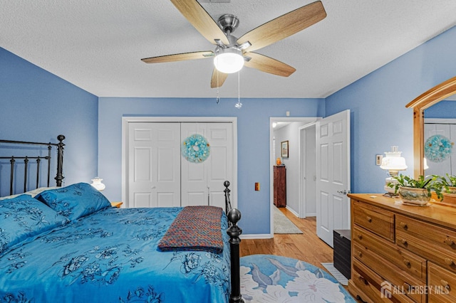 309 Sharon Way Unit A, Monroe, NJ 08831 - bedroom featuring wood finished floors, a ceiling fan, a closet, baseboards, and a textured ceiling