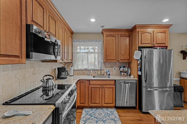 309 Sharon Way Unit A, Monroe, NJ 08831 - kitchen with brown cabinets, appliances with stainless steel finishes, tasteful backsplash, and a sink