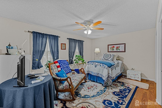309 Sharon Way Unit A, Monroe, NJ 08831 - bedroom with wood finished floors, a textured ceiling, and ceiling fan