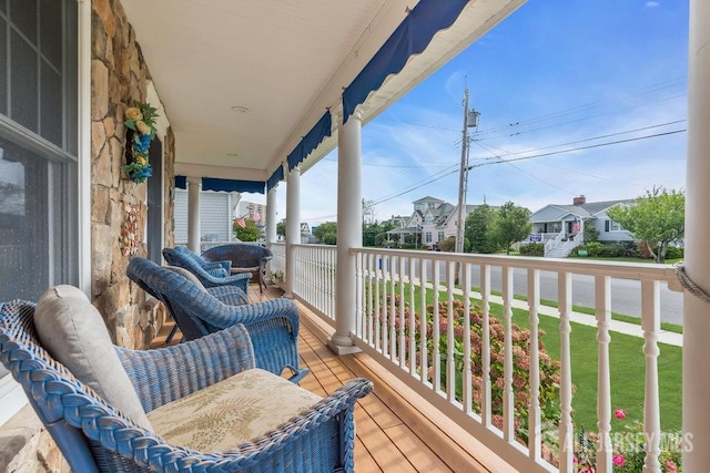 balcony with covered porch and a residential view