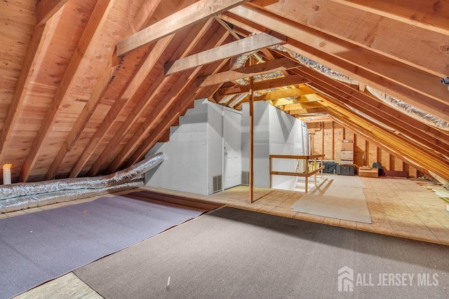 unfinished attic featuring an upstairs landing