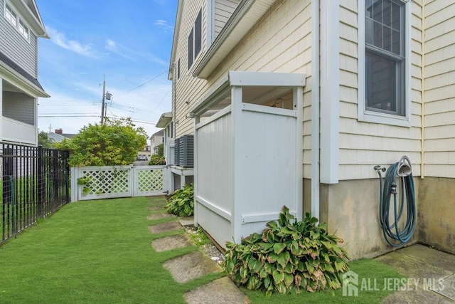 view of side of property featuring a yard and fence