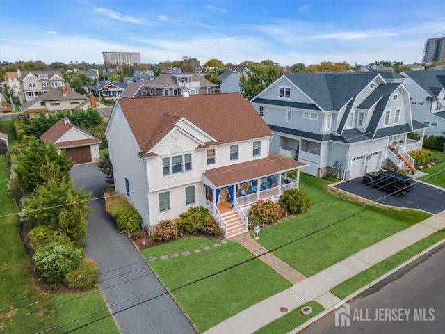 birds eye view of property with a residential view