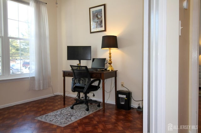 office space featuring plenty of natural light and baseboards