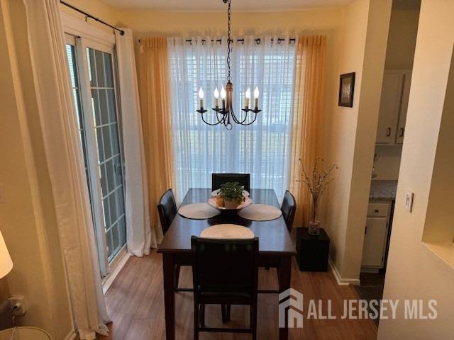 dining room featuring an inviting chandelier and wood finished floors