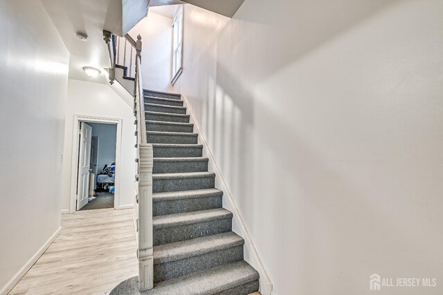 stairs featuring hardwood / wood-style flooring