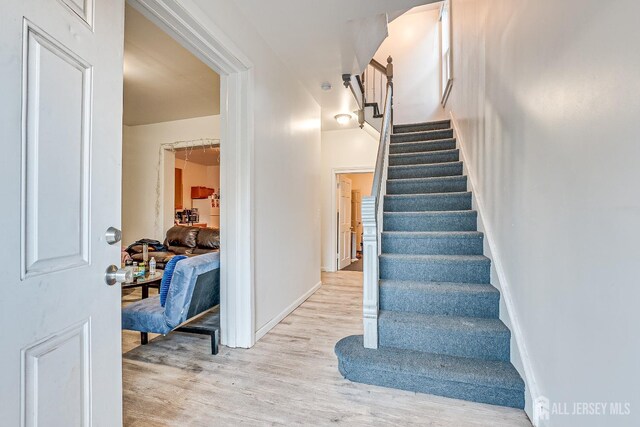 stairs with hardwood / wood-style flooring