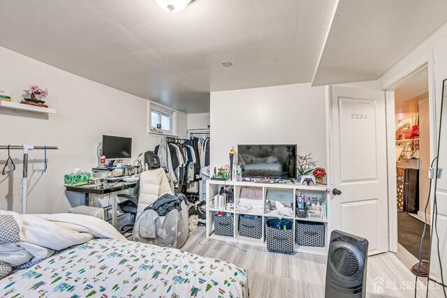 bedroom with a closet and light hardwood / wood-style flooring