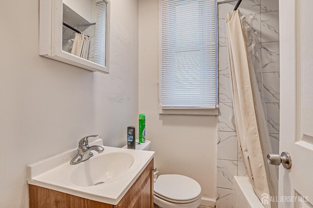 full bathroom with vanity, toilet, and shower / bath combo with shower curtain