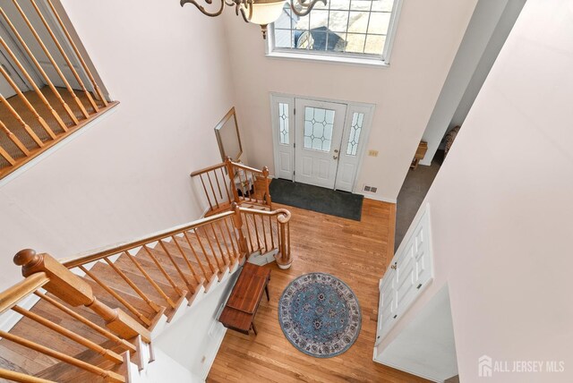 379 Sapphire Dr, Jackson, NJ 08527 - foyer with a towering ceiling, wood finished floors, stairway, and a chandelier