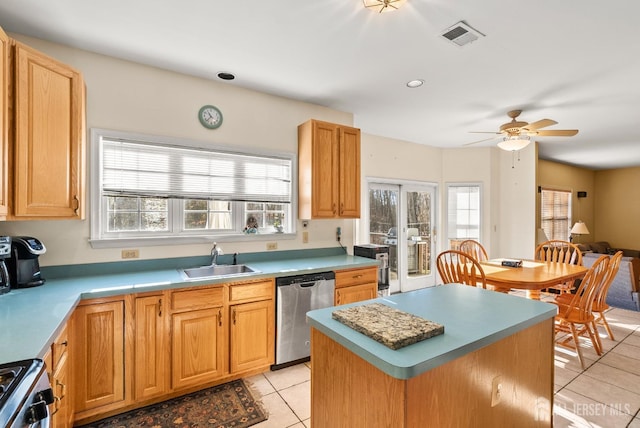 kitchen featuring sink, light tile patterned floors, range, a healthy amount of sunlight, and stainless steel dishwasher