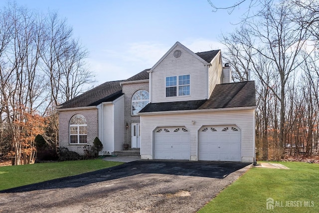 traditional home featuring aphalt driveway, a front yard, and roof with shingles