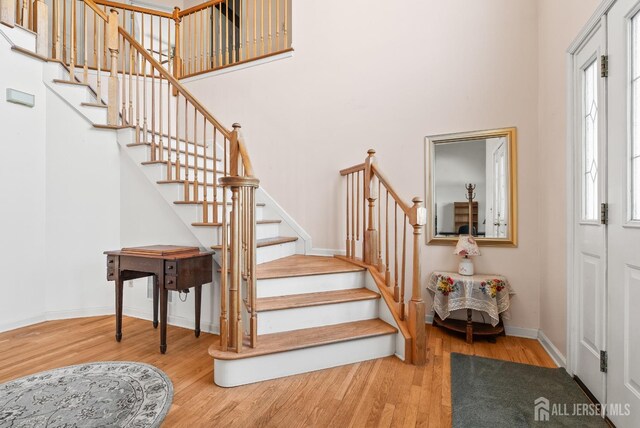 379 Sapphire Dr, Jackson, NJ 08527 - staircase featuring wood finished floors, baseboards, and a high ceiling