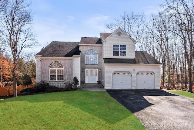 view of front property featuring a garage and a front yard