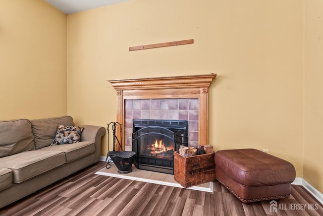 living room with hardwood / wood-style flooring and a fireplace