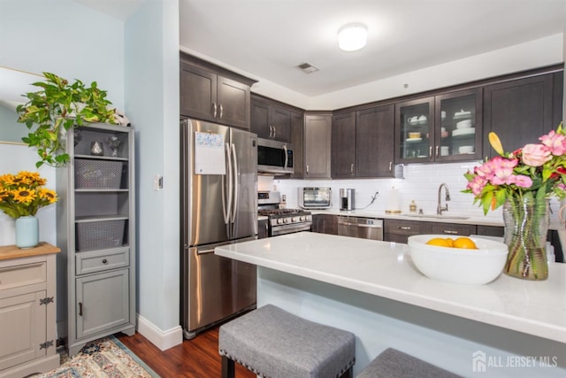238 Lucy Ct, South Plainfield, NJ 07080 - kitchen featuring dark brown cabinetry, stainless steel appliances, dark wood-style flooring, a sink, and visible vents