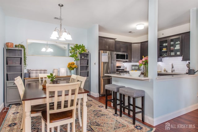 238 Lucy Ct, South Plainfield, NJ 07080 - kitchen featuring light wood-style flooring, backsplash, dark brown cabinets, and appliances with stainless steel finishes