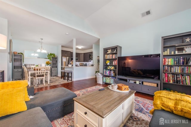 238 Lucy Ct, South Plainfield, NJ 07080 - living area featuring visible vents, wood finished floors, and a chandelier