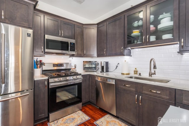 238 Lucy Ct, South Plainfield, NJ 07080 - kitchen featuring a sink, stainless steel appliances, dark wood-type flooring, dark brown cabinetry, and backsplash