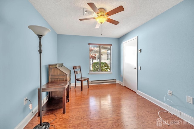 sitting room featuring a baseboard radiator, ceiling fan, a textured ceiling, and light hardwood / wood-style floors