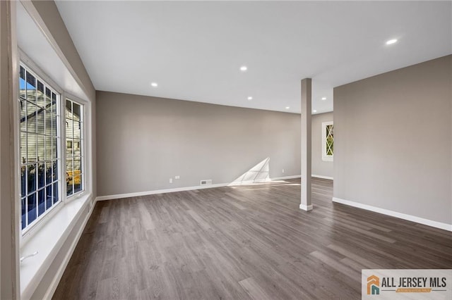 spare room with recessed lighting, visible vents, baseboards, and wood finished floors