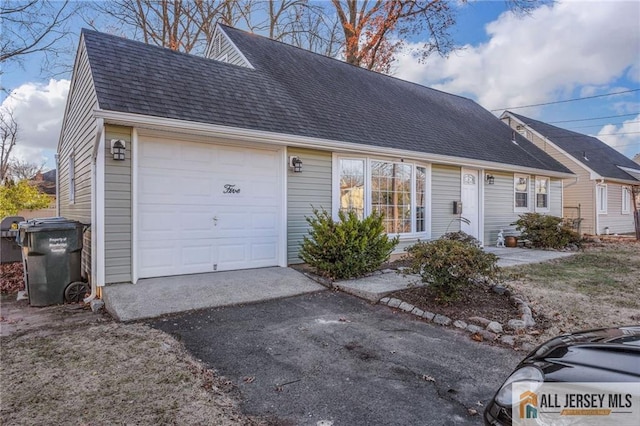 view of front of property with a shingled roof, driveway, and an attached garage