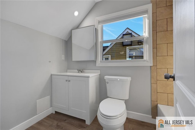 full bath with lofted ceiling, toilet, wood finished floors, vanity, and baseboards