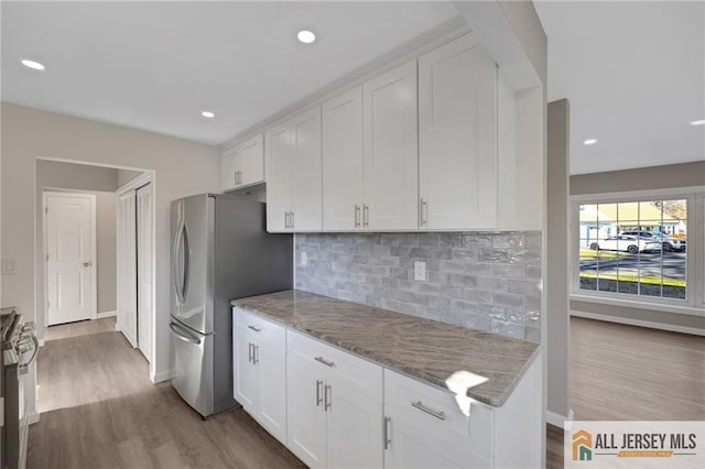 kitchen with stainless steel appliances, dark wood-style flooring, and white cabinetry