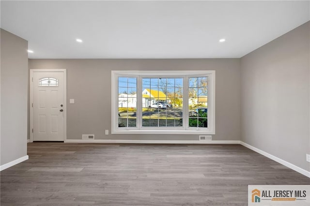 entrance foyer featuring recessed lighting, visible vents, baseboards, and wood finished floors