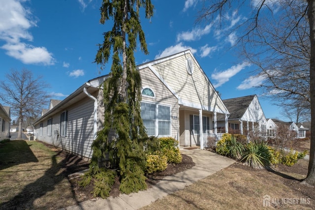 view of property exterior featuring a residential view and a porch