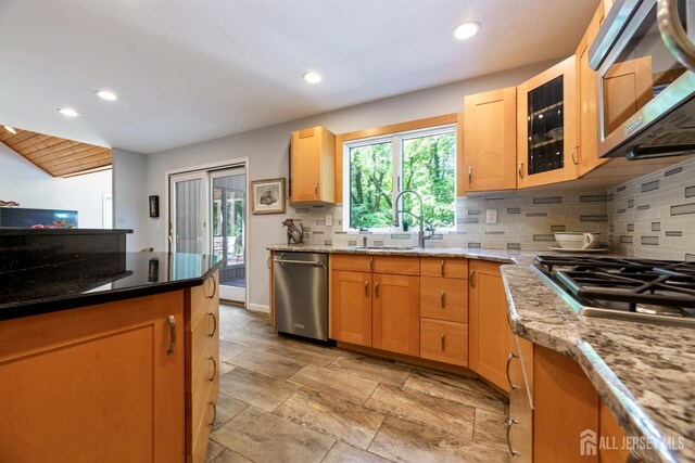 17 Theodore Dr, East Brunswick, NJ 08816 - kitchen with stainless steel appliances, backsplash, light stone counters, glass insert cabinets, and recessed lighting