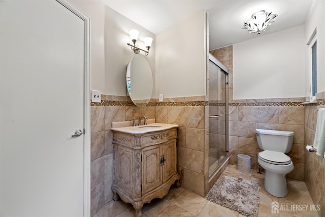 17 Theodore Dr, East Brunswick, NJ 08816 - full bath featuring tile walls, vanity, a shower stall, wainscoting, and tile patterned floors