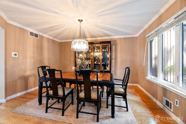 17 Theodore Dr, East Brunswick, NJ 08816 - dining area featuring a chandelier, healthy amount of natural light, crown molding, and wood finished floors
