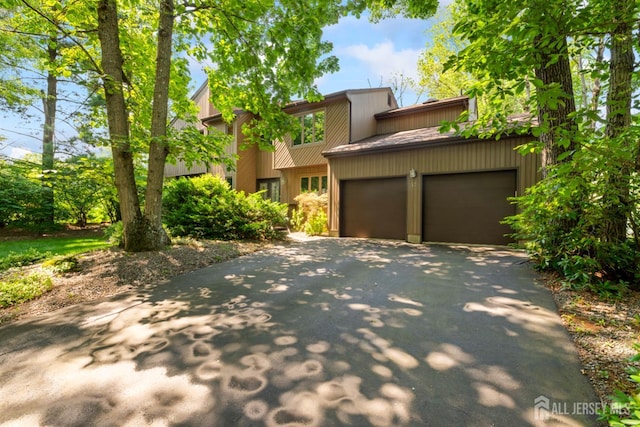 17 Theodore Dr, East Brunswick, NJ 08816 - view of front facade featuring asphalt driveway and a garage