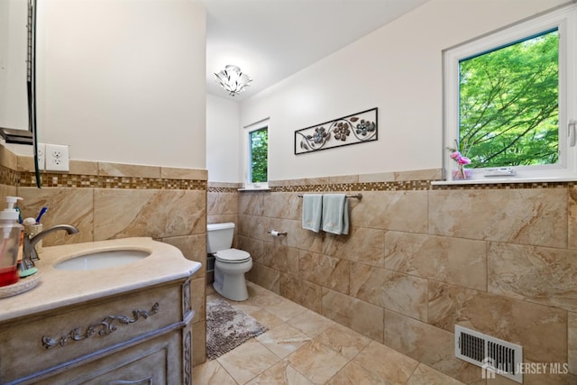 17 Theodore Dr, East Brunswick, NJ 08816 - bathroom featuring tile walls, vanity, and a wainscoted wall