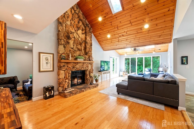 17 Theodore Dr, East Brunswick, NJ 08816 - living room featuring hardwood / wood-style floors, high vaulted ceiling, a skylight, a stone fireplace, and recessed lighting