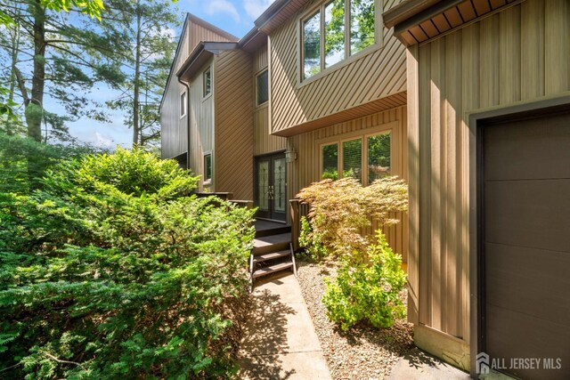 17 Theodore Dr, East Brunswick, NJ 08816 - view of exterior entry featuring french doors and board and batten siding