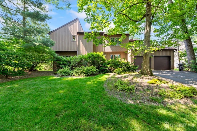 17 Theodore Dr, East Brunswick, NJ 08816 - view of front of house with asphalt driveway, a garage, and a front yard