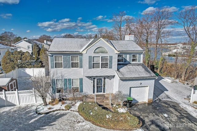 97 Laurel Ave, Hazlet, NJ 07734 - view of front of property featuring a chimney, aphalt driveway, a garage, and fence