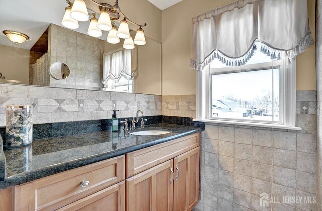 bathroom featuring vanity and tile walls