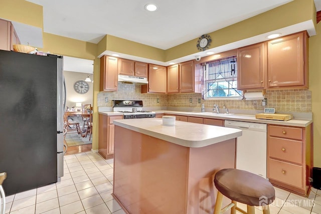 97 Laurel Ave, Hazlet, NJ 07734 - kitchen featuring light tile patterned floors, a sink, white appliances, under cabinet range hood, and light countertops