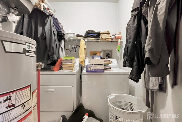 laundry area featuring separate washer and dryer and water heater