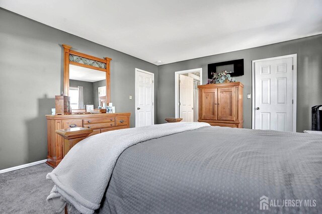 bedroom featuring carpet floors and baseboards