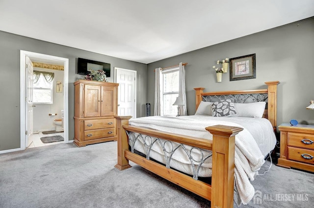 carpeted bedroom featuring ensuite bathroom