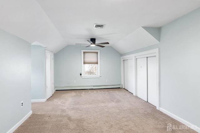 bonus room with a baseboard radiator, visible vents, light carpet, vaulted ceiling, and ceiling fan