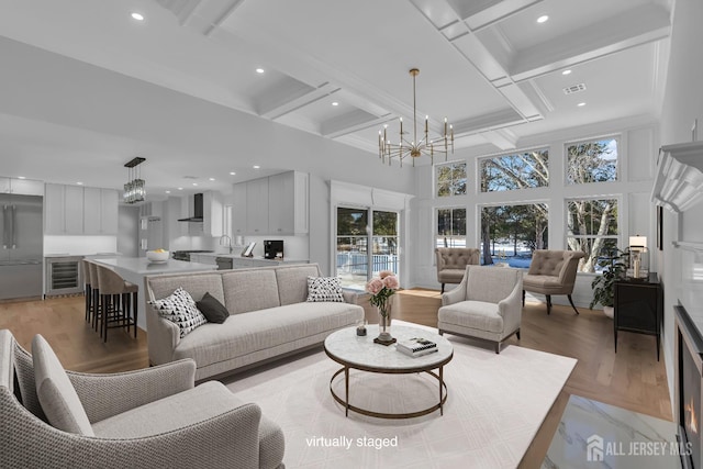 737 Wingate Dr, Bridgewater, NJ 08807 - living area featuring wine cooler, a chandelier, healthy amount of natural light, a high ceiling, and recessed lighting