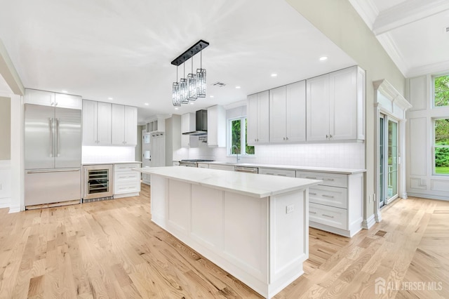737 Wingate Dr, Bridgewater, NJ 08807 - kitchen featuring built in refrigerator, beverage cooler, wall chimney range hood, backsplash, and a center island